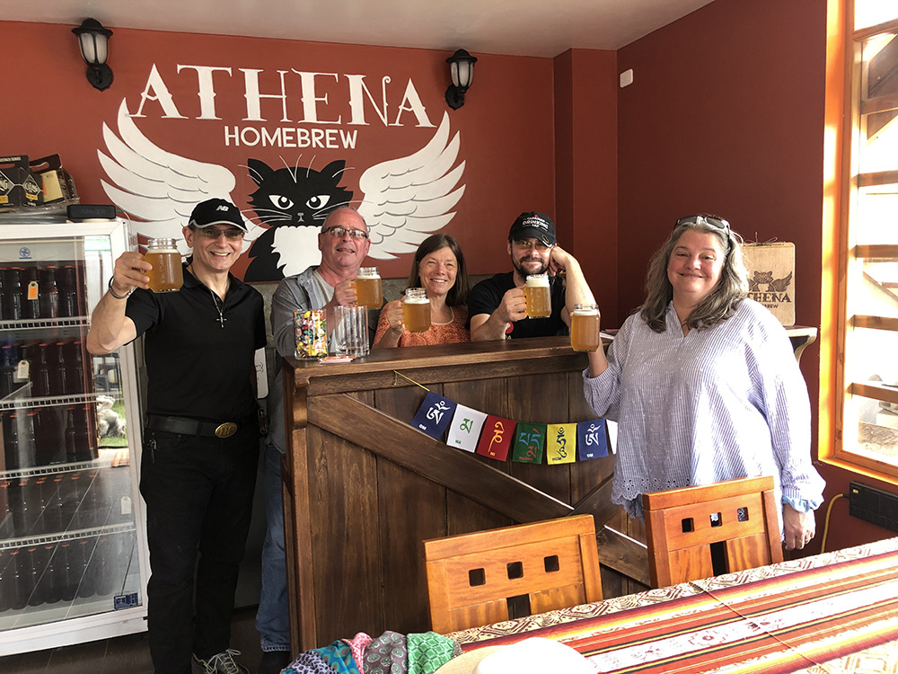 People posing in front of Athena Homebrew bar