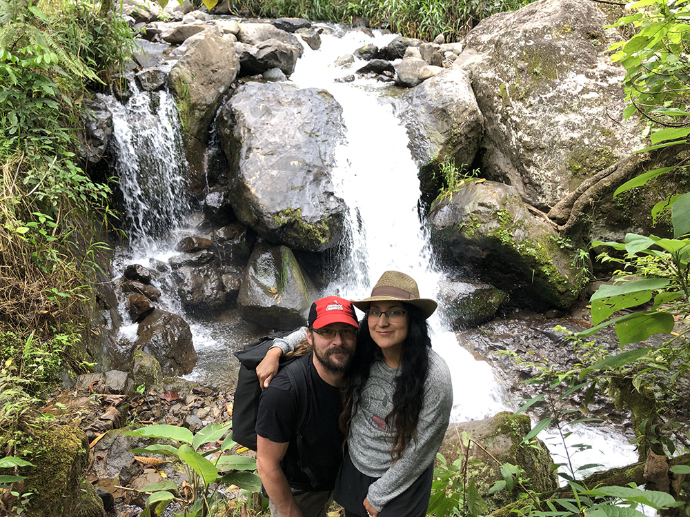 Malena and Roger in front of a water fall.