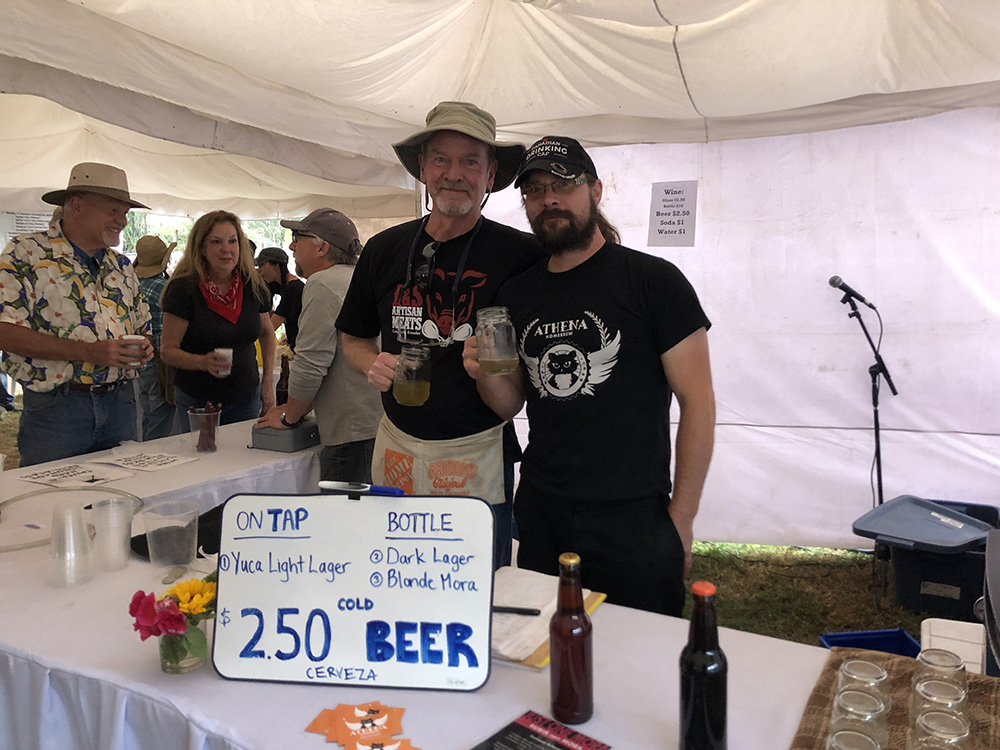 Chili Cook Off Chuck and Roger standing in front of their stands.